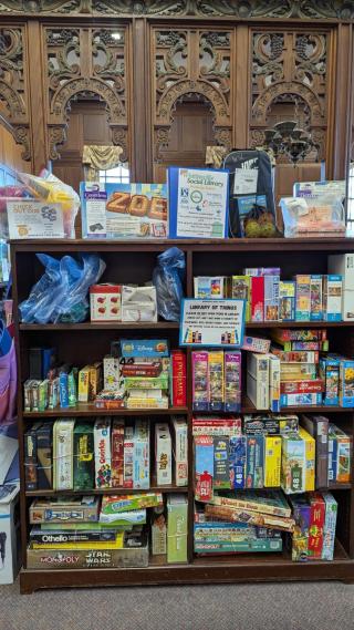 Whitinsville Social Library of Things collection - shelves of board games, puzzles, and household items available to borrow with a library card